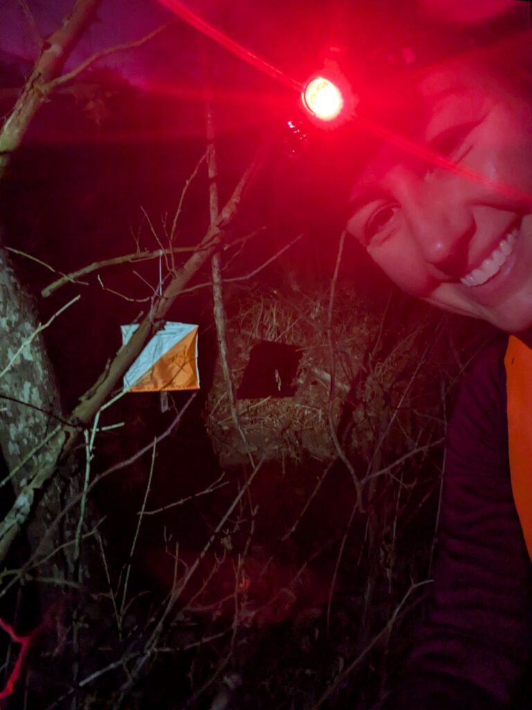 Race at checkpoint during nighttime adventure race.