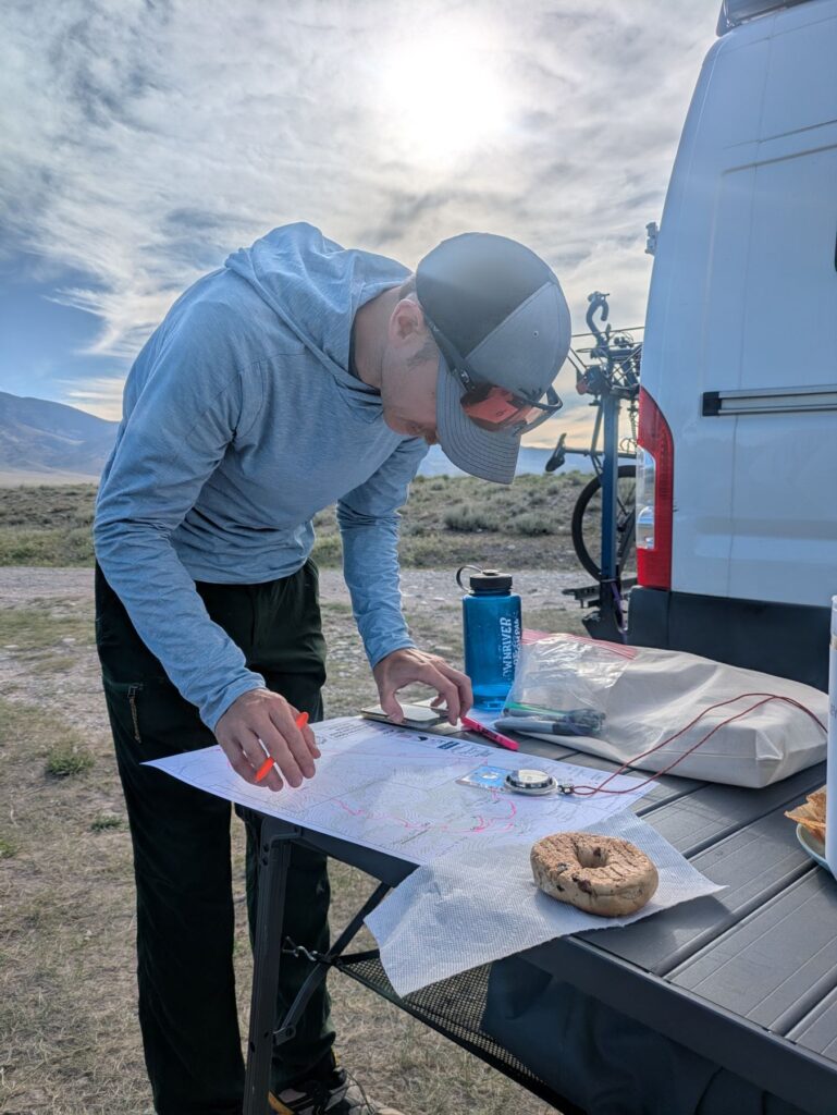 Racer mapping out the Teton Ogre Adventure race route using the pre-plotted map.