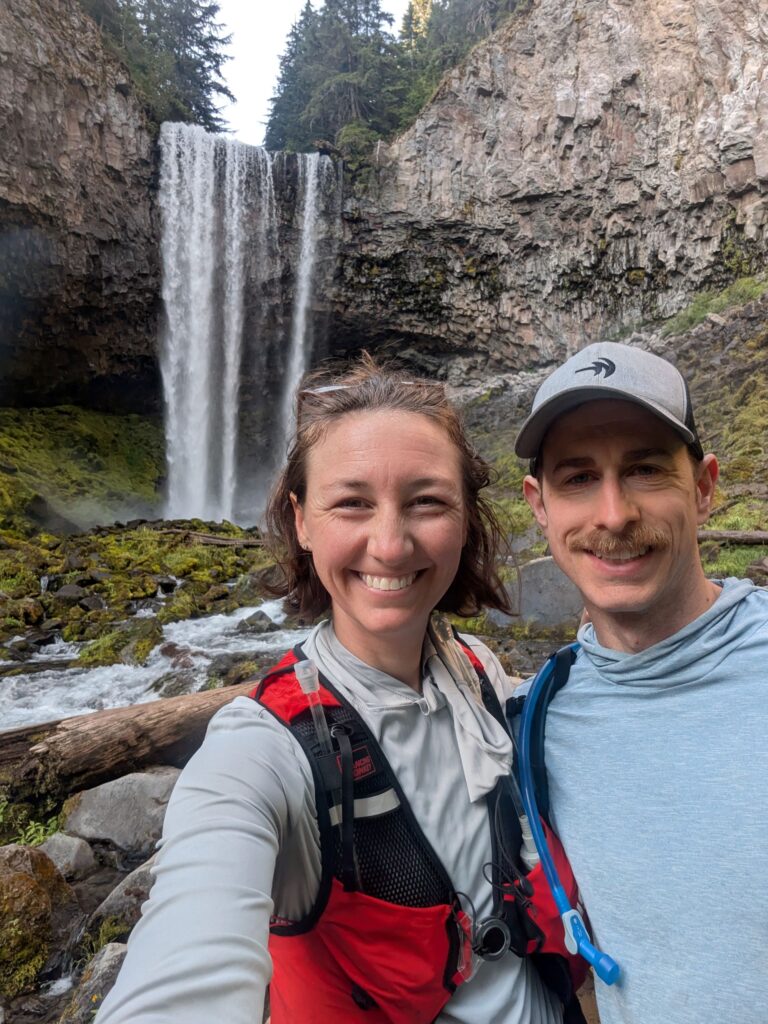 Two people at Tamanawas Falls in Oregon