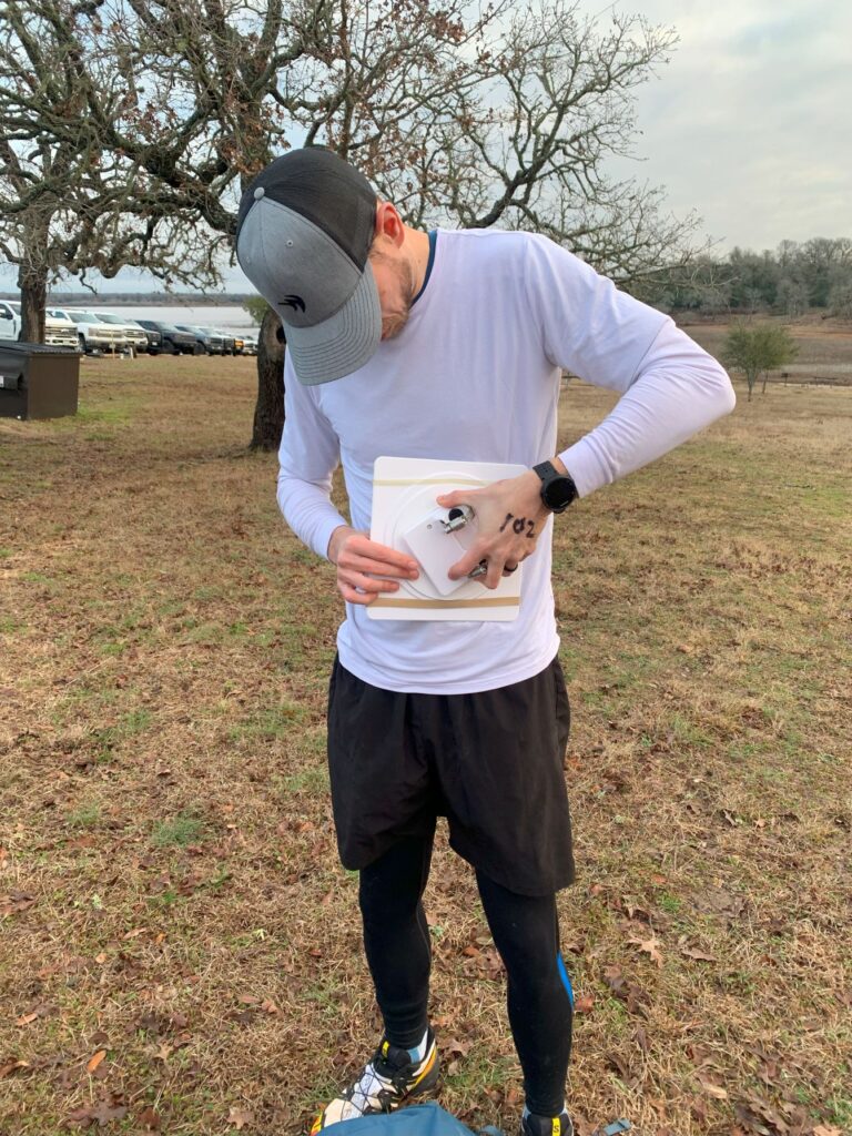 Adventure racer adjusts a map board