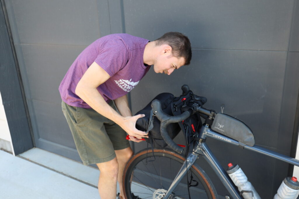 Man adjusting gear on bike.